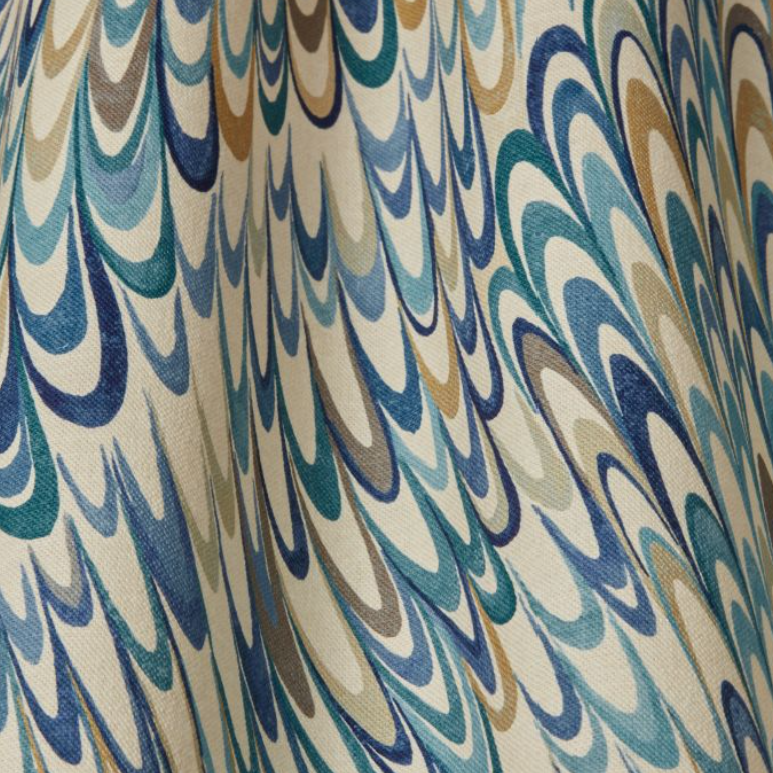 A close-up of a fabric or wallpaper pattern featuring a marbled, feather-like wave design in blue, teal, brown, and beige tones.