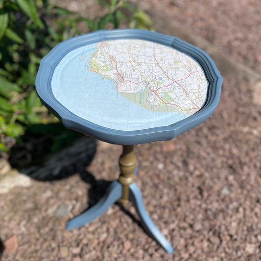small round table with a map on top outdoors