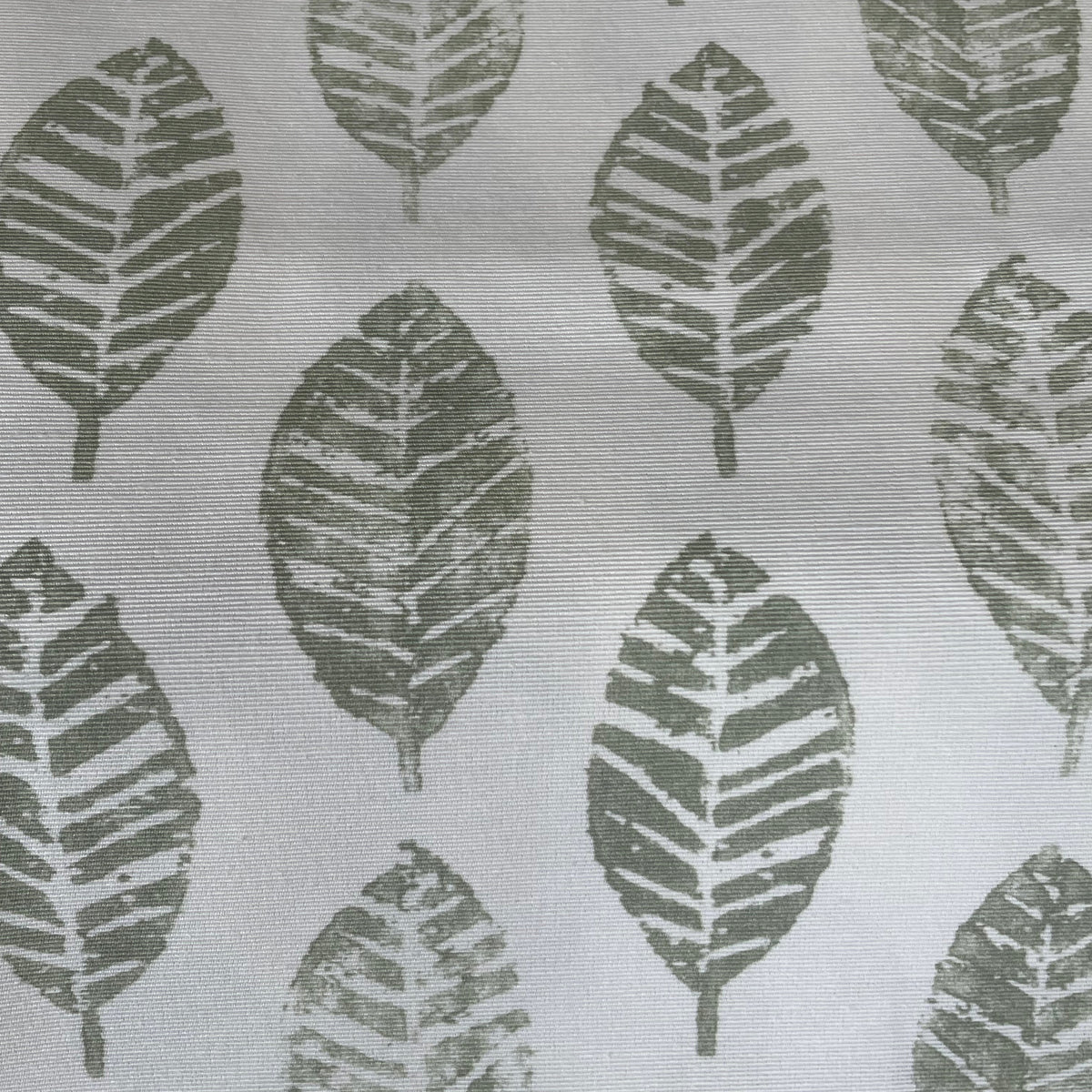 A close-up of a fabric or wallpaper pattern featuring dark olive green leaf silhouettes printed on a white textured background.